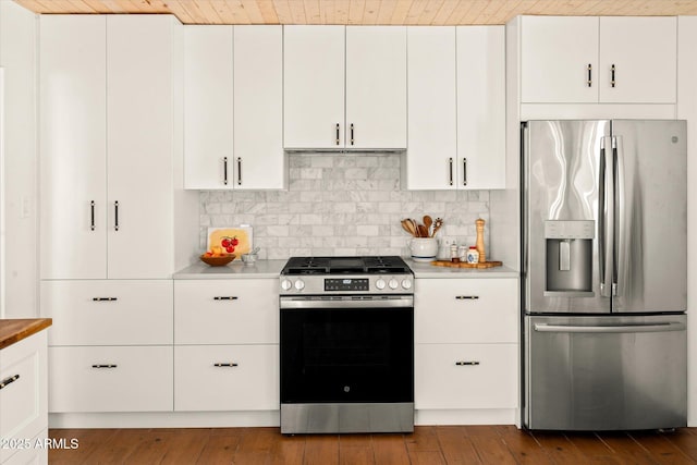 kitchen with tasteful backsplash, wooden ceiling, stainless steel appliances, light hardwood / wood-style floors, and white cabinets