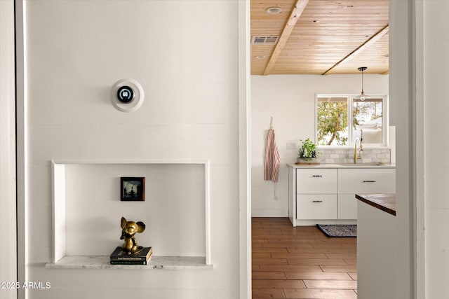 hall with sink, hardwood / wood-style floors, and wood ceiling