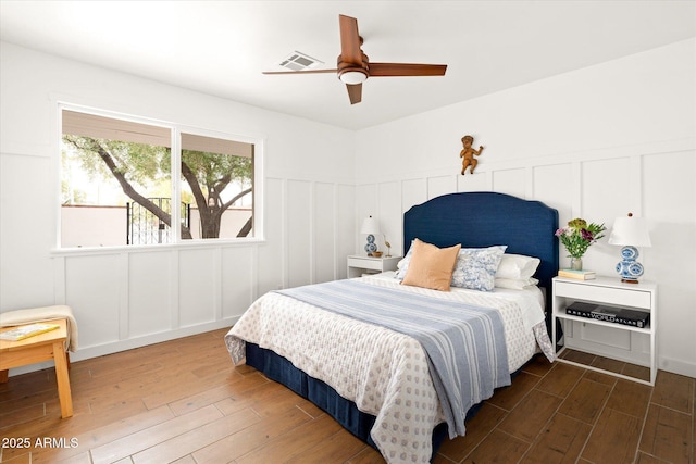 bedroom with dark wood-type flooring and ceiling fan