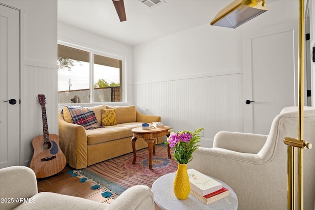 living room featuring hardwood / wood-style flooring and ceiling fan