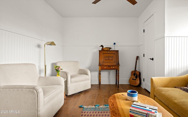 living room featuring wood-type flooring and ceiling fan