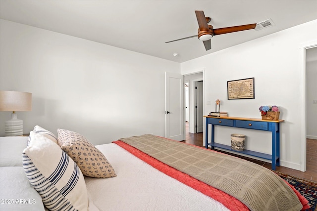 bedroom with dark hardwood / wood-style flooring and ceiling fan