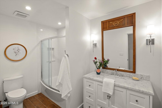 full bathroom with vanity, combined bath / shower with glass door, and toilet