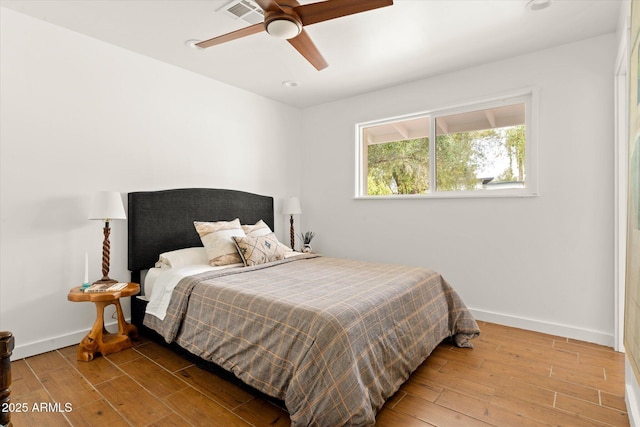 bedroom with hardwood / wood-style flooring and ceiling fan