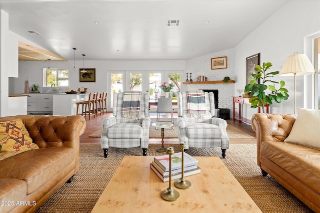 living room featuring sink, a fireplace, and french doors