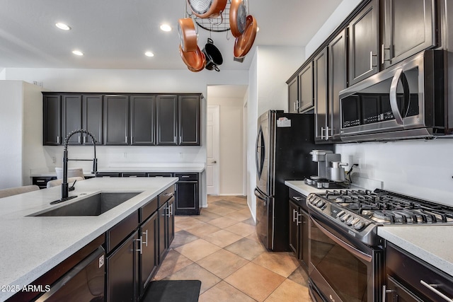 kitchen featuring light tile patterned floors, appliances with stainless steel finishes, sink, and dark brown cabinets