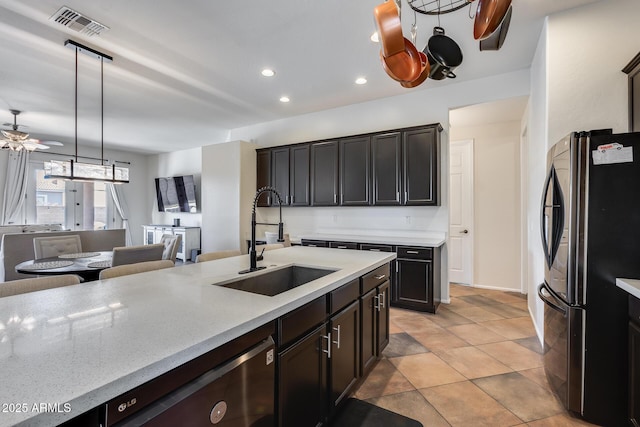 kitchen with black refrigerator, ceiling fan, decorative light fixtures, dishwasher, and sink