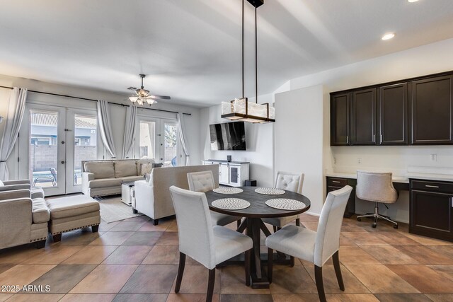 dining area with ceiling fan, french doors, and built in desk