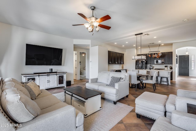 tiled living room featuring ceiling fan