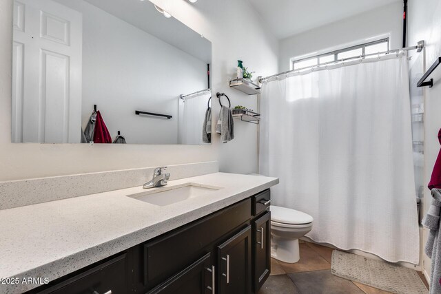 bathroom with toilet, tile patterned floors, and vanity