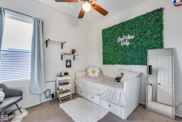 bedroom featuring ceiling fan and carpet