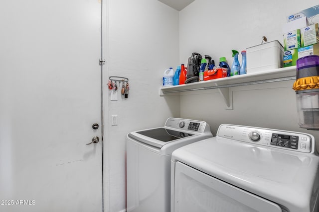 washroom with washing machine and clothes dryer