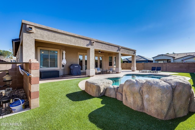 view of swimming pool featuring a lawn and a patio