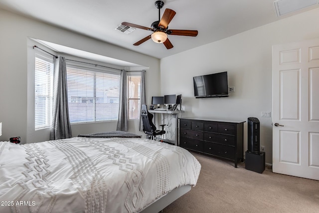 bedroom with light carpet, ceiling fan, and multiple windows