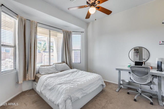 bedroom with ceiling fan and light colored carpet