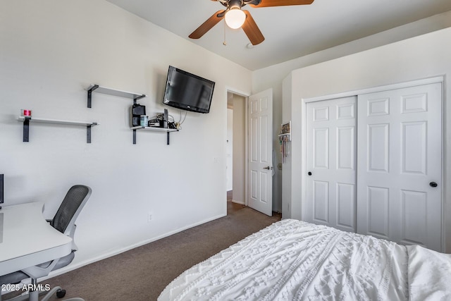 bedroom featuring ceiling fan, a closet, and dark colored carpet