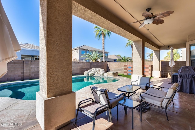 view of patio / terrace featuring ceiling fan and a fenced in pool