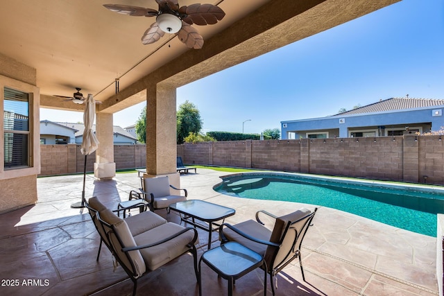 view of swimming pool featuring ceiling fan and a patio