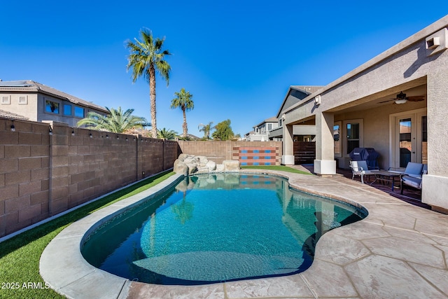 view of pool with ceiling fan and a patio