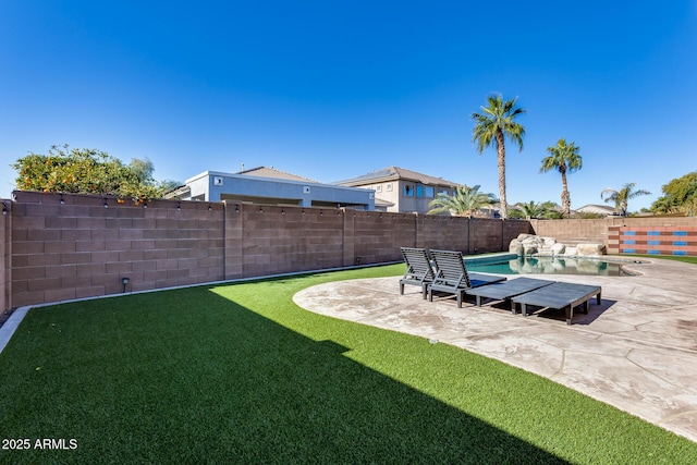 view of yard featuring a fenced in pool and a patio area