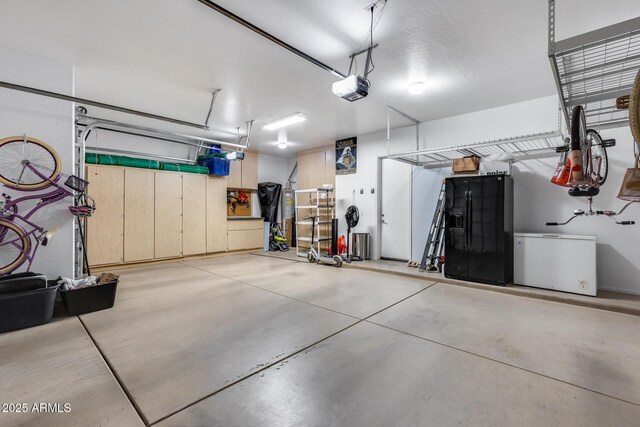 garage featuring refrigerator and a garage door opener