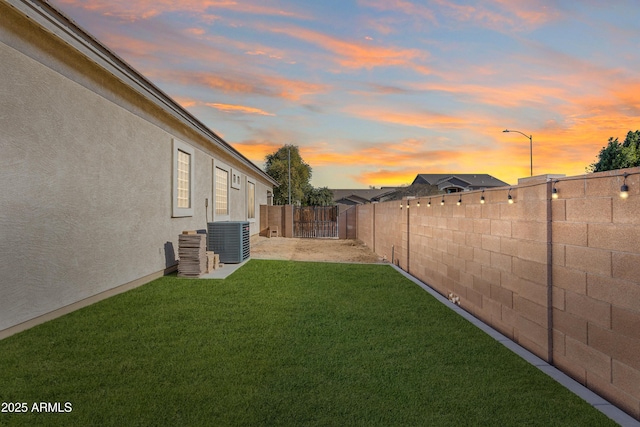 yard at dusk featuring cooling unit