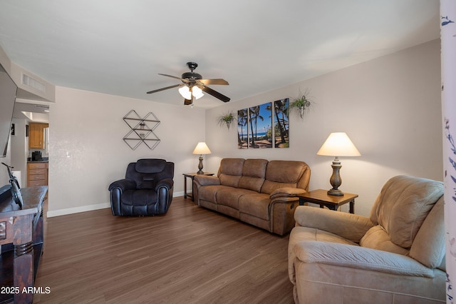 living room with baseboards, a ceiling fan, and wood finished floors