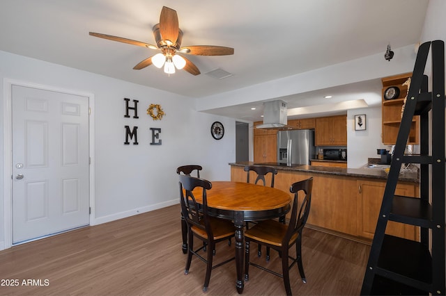 dining area with wood finished floors, a ceiling fan, baseboards, and recessed lighting