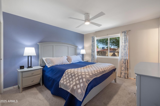 bedroom featuring light carpet, baseboards, and ceiling fan