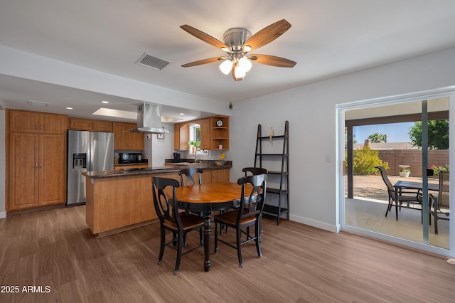 dining room with wood finished floors, baseboards, a ceiling fan, and recessed lighting