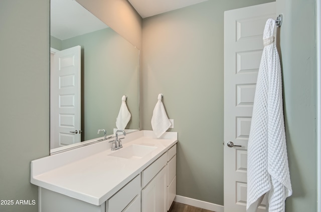 bathroom with vanity and baseboards