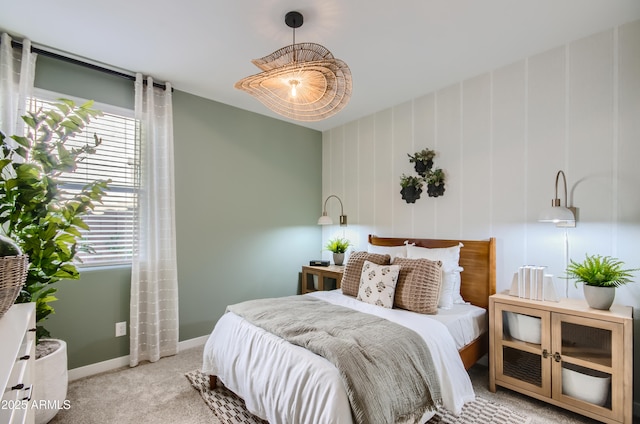 bedroom featuring light colored carpet and baseboards