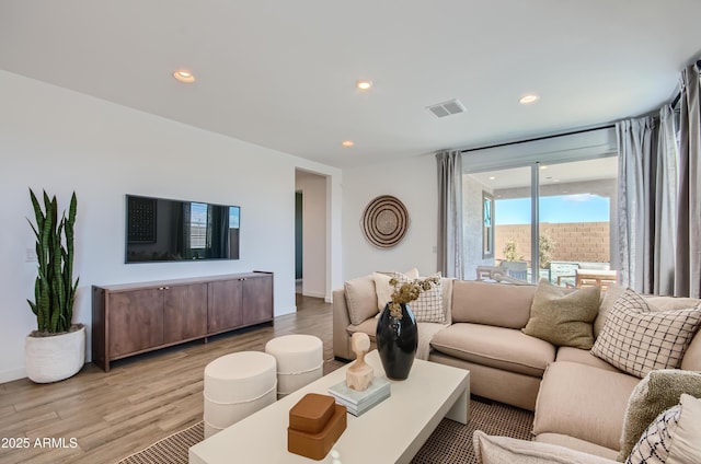 living room featuring recessed lighting, visible vents, and light wood-style floors