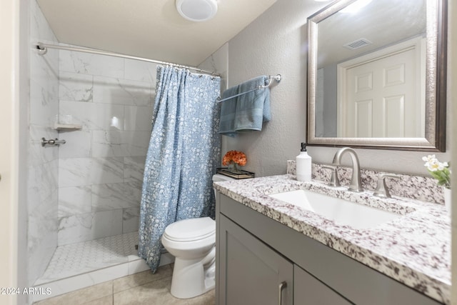 bathroom with tile patterned floors, vanity, toilet, and a shower with shower curtain