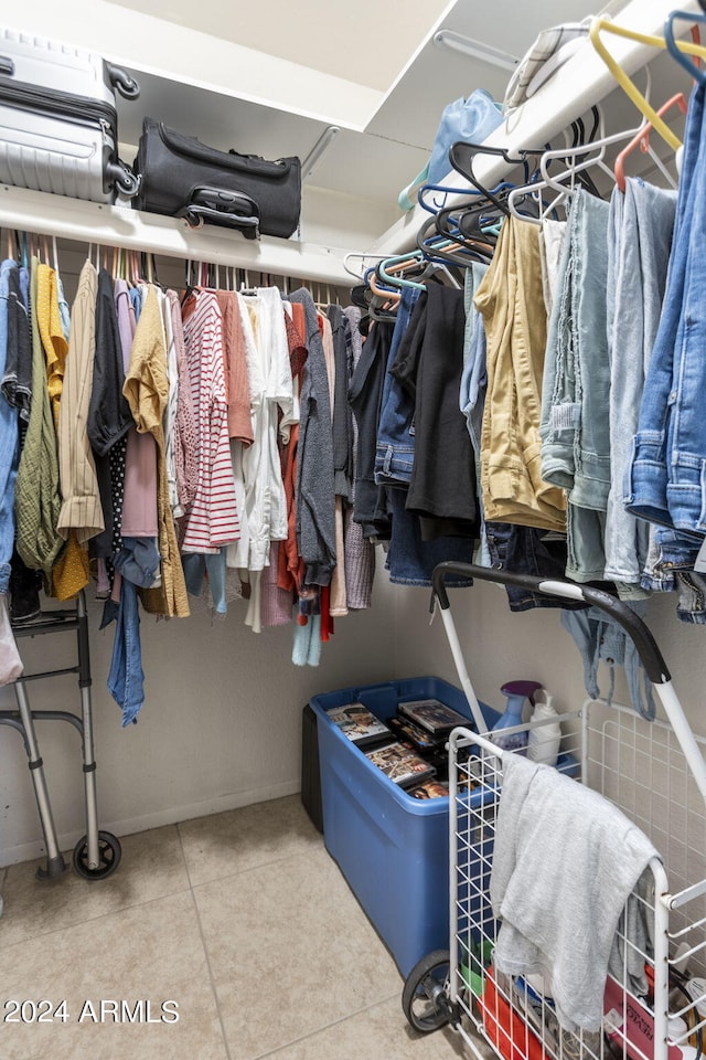 spacious closet featuring light tile patterned floors