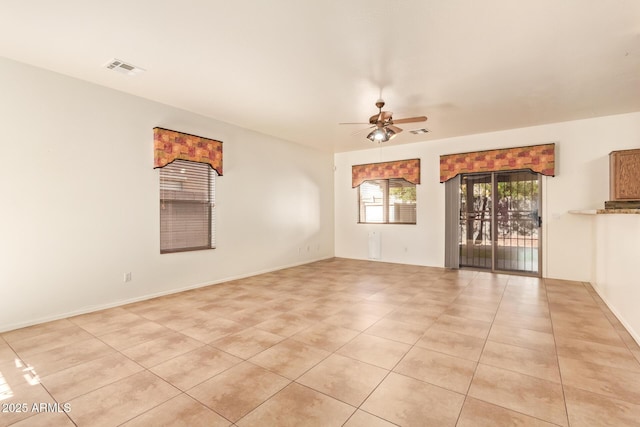 tiled empty room with ceiling fan