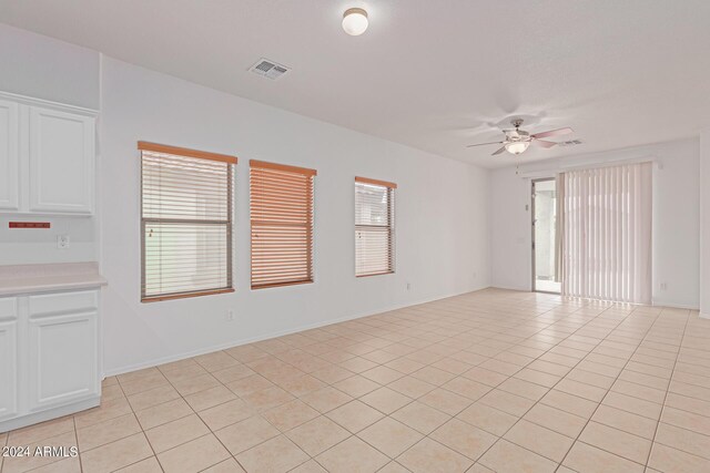 interior space with ceiling fan