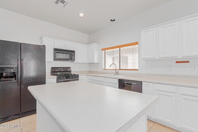 kitchen featuring black appliances, white cabinetry, a center island, and sink