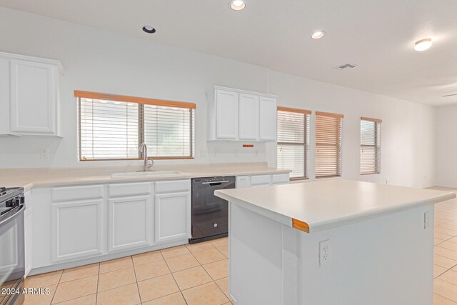 kitchen featuring dishwasher, a kitchen island, a healthy amount of sunlight, and white cabinetry