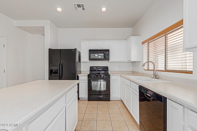 kitchen featuring black appliances, white cabinetry, sink, and light tile patterned floors