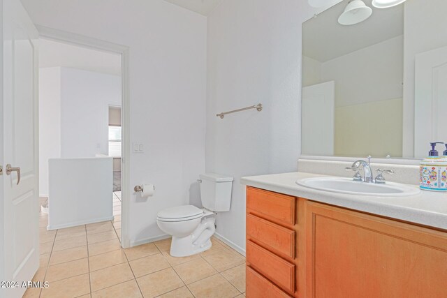 bathroom with vanity, toilet, and tile patterned floors