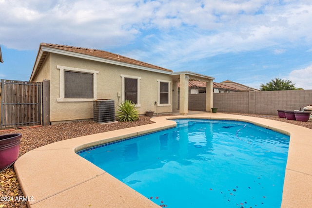 view of swimming pool with central AC unit