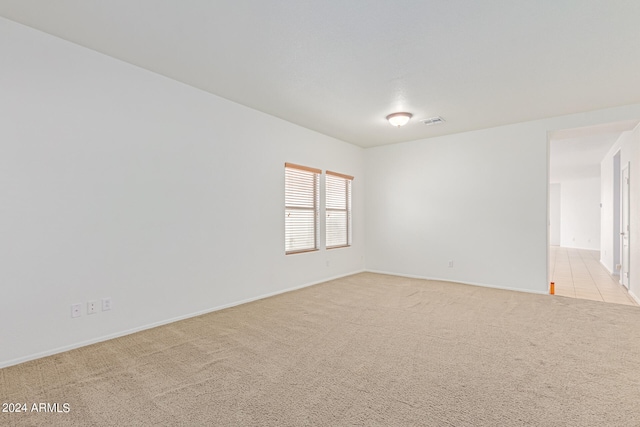 unfurnished room featuring light colored carpet