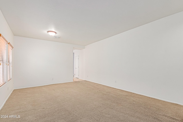 spare room with light colored carpet