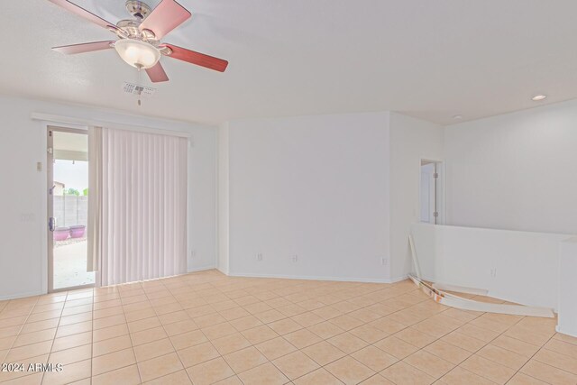 tiled empty room with ceiling fan