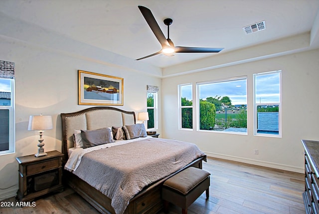 bedroom with ceiling fan and light hardwood / wood-style floors