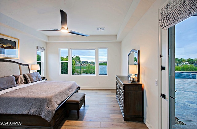 bedroom with ceiling fan, hardwood / wood-style floors, and access to outside