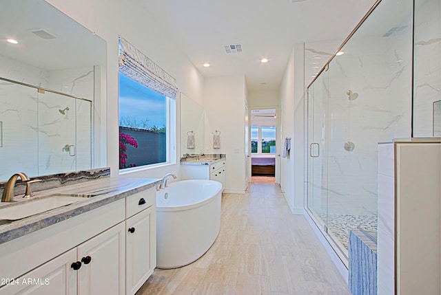 bathroom featuring vanity and plus walk in shower