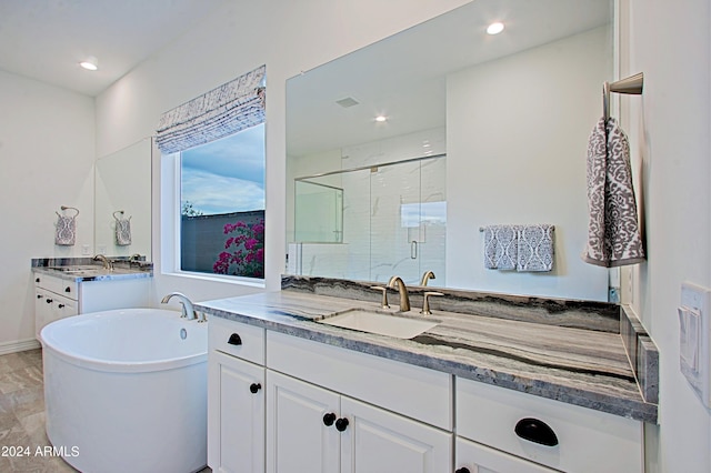 bathroom with shower with separate bathtub, tile floors, and vanity