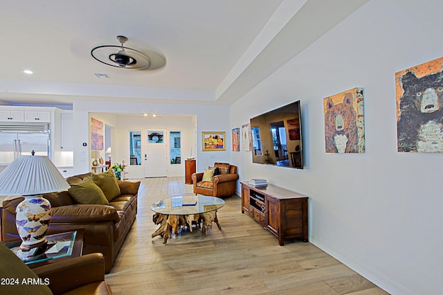 living room with ceiling fan and light hardwood / wood-style floors